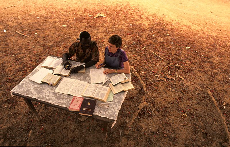 People sitting at a table in the desert